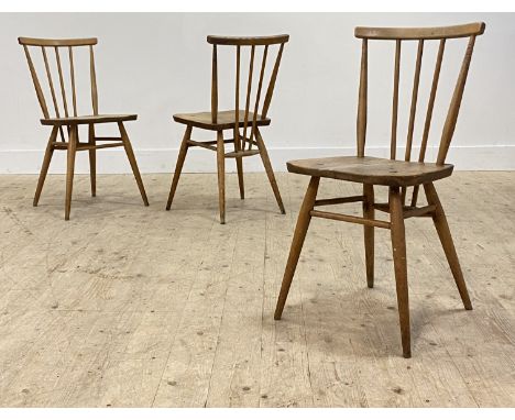 Ercol, a set of three beech and elm comb back dining chairs, mid 20th century. H60cm