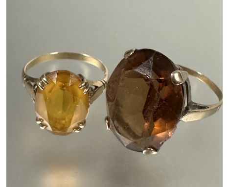 A 9ct gold oval cut citrine solitaire ring, L (L x 1.3cm X W 1cm) and a yellow metal set oval cairngorm style cut glass, N. (