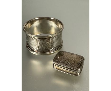 A silver rectangular engraved pill box, ( H x 1cm x L x 3cm ) and a Birmingham silver engine turned napkin ring. (2) 30.5g