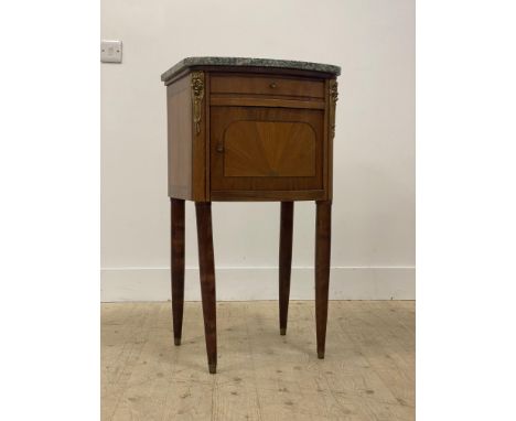 A French Kingwood and walnut bedside cabinet / night commode, the green serpentine marble top over a drawer and bow front cup