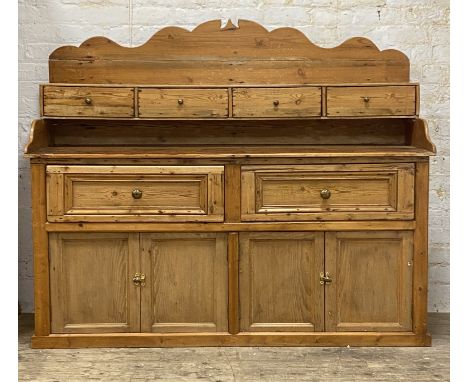 A 19th century Scotch pine dresser, the shaped raised back over four spice drawers, the base with two drawers over four panel