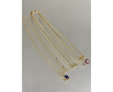 A 9ct gold snake link chain necklace with lobster claw fastening and yellow metal ruby and diamond cluster pendant, (L x 24.5