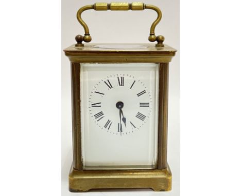 A miniature carriage clock with white enamel dial and roman numeral indices, possibly Edwardian (h- 14cm including handle)
