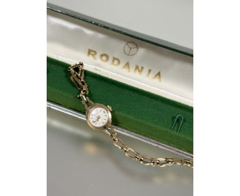 A Rodania Lady's 9ct gold manual wind wristwatch with silvered dial and Arabic numerals at the quarter hours and baton marker