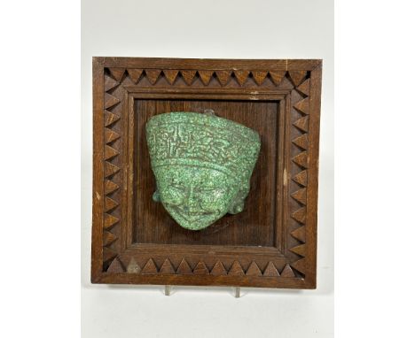 A Inca mosaic green stone moulded mask mounted in a oak frame. ( mask H x 13cm x L 13cm)