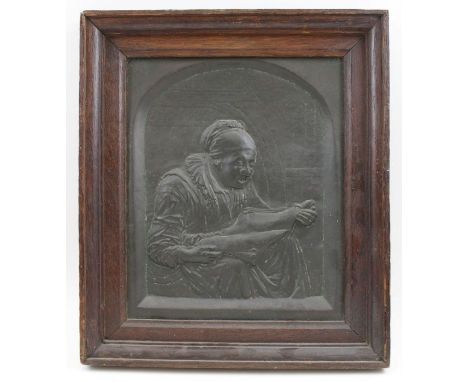 A 19th century embossed copper panel of an old lady reading, 27cm x 22cm, in an oak frame