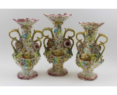 A garniture set of three Victorian Colebrookdale type ceramic vases, each of baluster form, with scrolling handles, floral en
