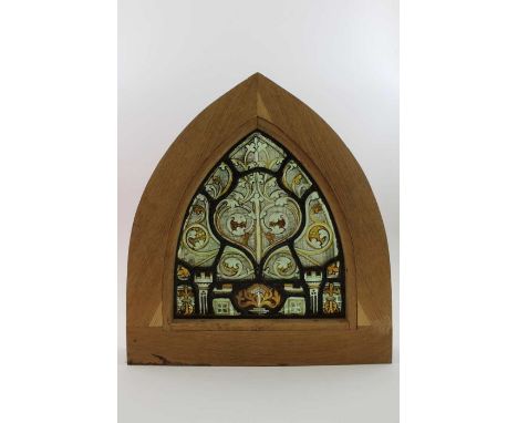 An early painted &amp; leaded glass panel of arch form, decorated with acanthus leaves, mostly in yellow, mounted into an oak