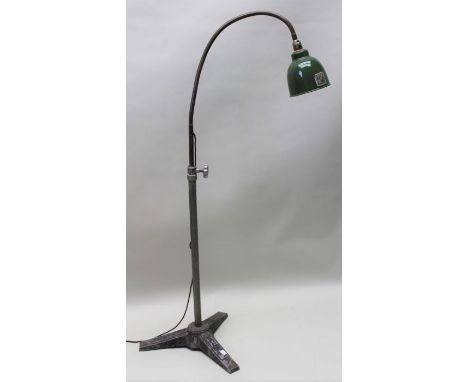 A industrial standard lamp with green shade and tri pod stand 