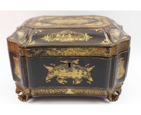 A 19th-century Chinese gilded black lacquer tea caddy, raised on carved paw feet, the hinged cover revealing twin metal caddi