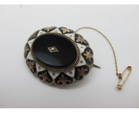A Victorian Enamel Locket Back Mourning Brooch, with oval collet set centre and seed pearl highlight, glazed panel verso. 