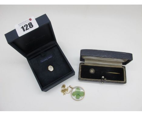 A 9ct Gold Oval Inset Tie Tack, together with a vintage tie pin, of circular design with star set highlight, stamped "15c", a