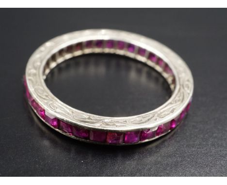 A ruby and precious white metal eternity ring, the square-cut stones channel-set and of 2 ct aggregate weight, 2.09 g, size N