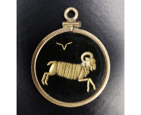 A late 20th Century astrologically carved green jade and yellow metal pendant, comprising a disc intaglio engraved in depicti