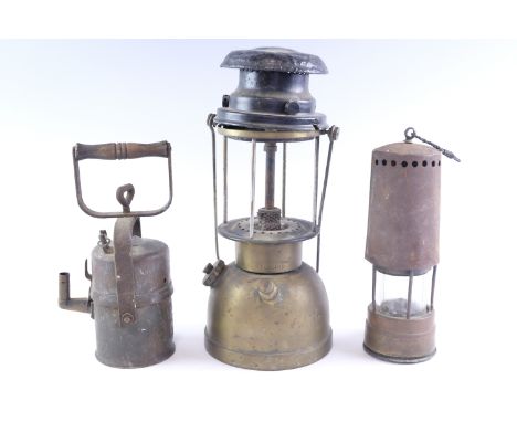 An early 20th Century carbide lamp, 'Wolflite' by the Wolf Safety Lamp Co, Sheffield, a miner's safety lamp and an Aladdin pa