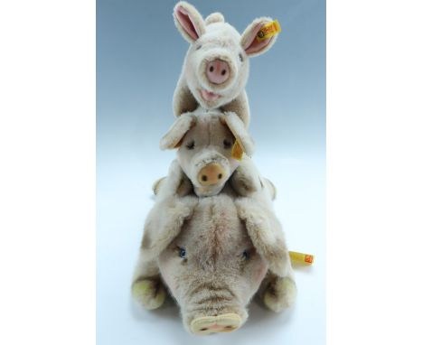 Three vintage Steiff pigs, two with tags, largest 48 cm