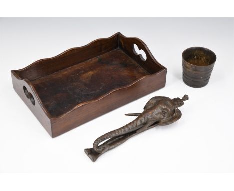 A vintage novelty cast iron nut cracker modelled as an elephant's head with rider atop, a Victorian mahogany tray, and a horn