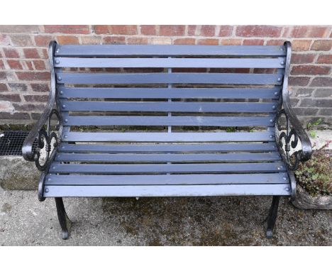 A cast iron garden bench, having wooden slats, approximately 120 x 65 x 78 cm