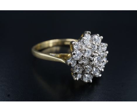 A late 20th Century cluster set diamond dress ring, comprising a 3 mm brilliant diamond above a surrounding circle of eight 2