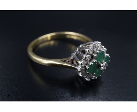 An emerald and diamond dress ring, having a square of four 3 mm emeralds, centred with an eight-cut diamond, and terraced abo