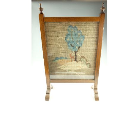 A George VI oak firescreen, having a gross-point tapestry landscape, 50.5 x 84 cm