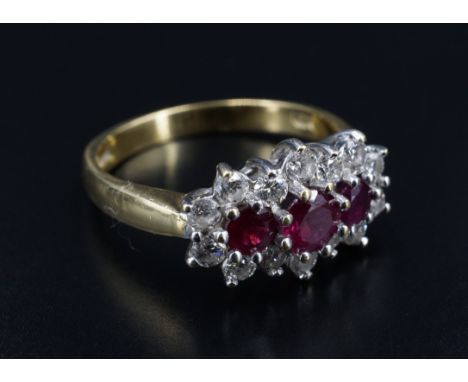 A ruby and diamond triple-cluster ring, the largest, central ruby of approx .33 ct, the brilliant-cut diamonds of approximate