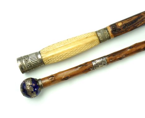 An early 20th Century Chinese walking stick, having an enamelled electroplate pommel decorated with dragons, above a silver c