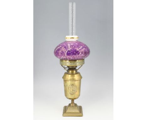 A brass oil lamp, having a parcel gilt lustre shade, second quarter 20th Century, 46 cm