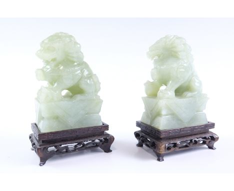 A pair of Chinese jade temple guardians, 14 cm high (on plinth)