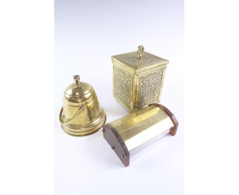 A 1930s brass tea caddy, of cubic form profusely embossed with Damascus influenced decoration and having an Isle of Man trisk