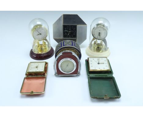 Six various mid-to-late 20th Century clocks, comprising an enamelled nickel-silver alarm clock and one other, two travel cloc