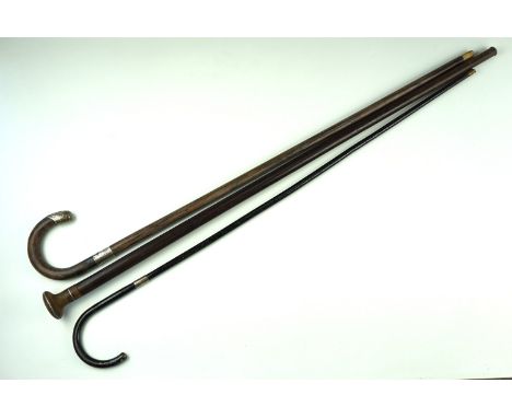 Two early 20th Century crook handled silver mounted walking sticks, comprising ebonised and ebony shafted, respectively Chest