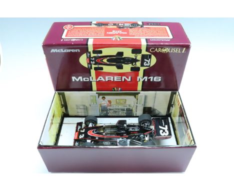 A boxed Carousel 1 diecast 1:18 scale model of the McLaren M16 from the 1974 Indianapolis (Indy) 500