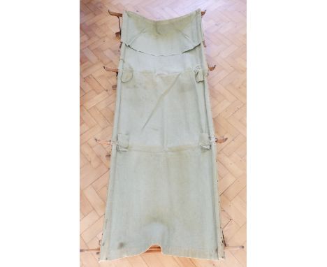 A Great War British / Indian Army officer's folding camp bed and canvas bag, the latter inscribed "I S Clarke, 57th Rifles, F