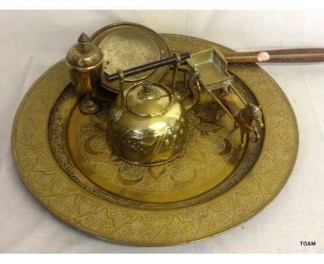A large brass embossed salver, brass kettle and other brassware