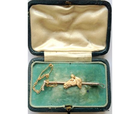 A 9ct gold stick pin with horse and crop