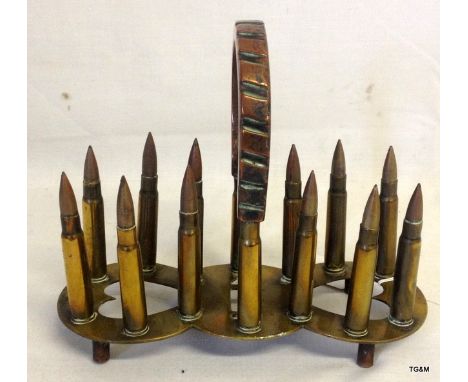 An unusual trench art letter rack made from used bullets and a copper drive band
