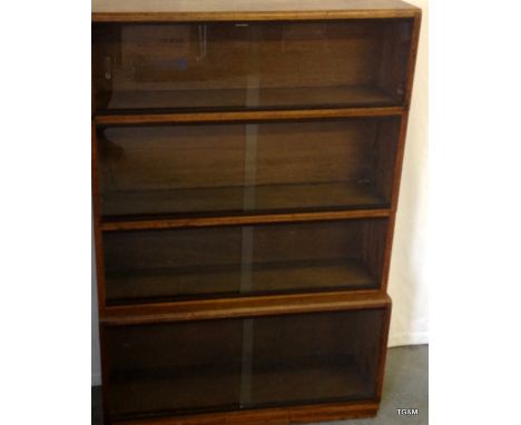 A Simplex 4 sectional bookcase in light oak with glass doors 135cm high 92cm wide 28cm deep