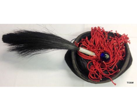 A Chinese Black Mandarin Winter Court hat denoting the position in court with feathers with a white jade fitment and blue bob