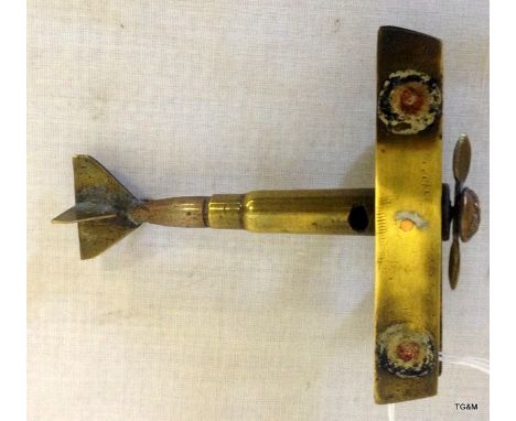 A trench art British biplane with a 9 cms wingspan having a moving propeller and wheels