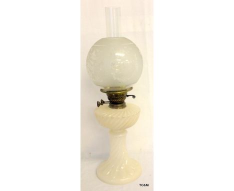 A Vaseline glass oil lamp with an engraved glass shade 59cm high