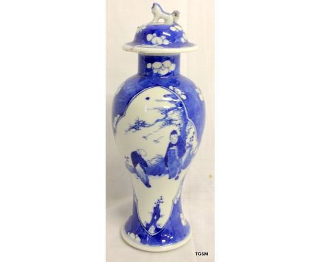 C19th Chinese blue and white baulster vase with lid, figures in panels on prunus background.  28cm high