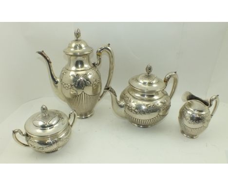 A GERMAN FOUR PIECE SILVER TEA AND COFFEE SERVICE, of fluted form with repousse swags and ribbons, comprising coffee pot, tea