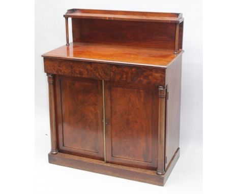 A 19TH CENTURY MAHOGANY CHIFFONIER, gallery shelf on forward columns mounted upon a base fitted with two concealed frieze dra