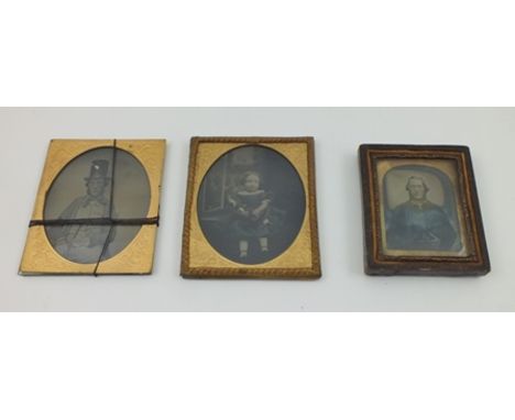 THREE 19TH CENTURY PHOTOGRAPHS, portraits,  includes a gentleman wearing a top hat and a child cradling a doll, 7cm x 6cm (3)