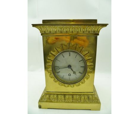 A 19TH CENTURY REGENCY DESIGN GILT METAL CASED MANTEL CLOCK, of plain form with starburst surround to the silvered dial with 