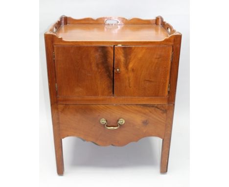 A 19TH CENTURY MAHOGANY NIGHT COMMODE BEDSIDE CABINET, having gallery top with pierced handles, over two cupboard doors over 