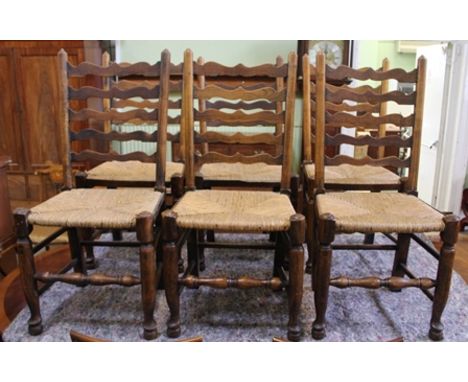 A SET OF EIGHT PROVINCIAL LADDER BACK DINING CHAIRS comprising; a pair of open armchairs and six singles, turned forelegs and