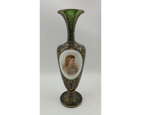 A LATE 19TH CENTURY BOHEMIAN GREEN GLASS VASE, gilded and with a hand painted oval panel depicting a shoulder length portrait