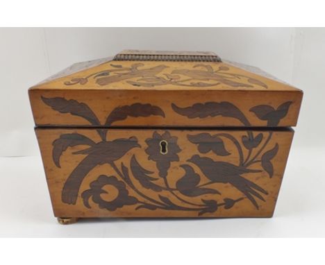 AN EARLY 19TH CENTURY DECORATIVELY INLAID SATINWOOD TEA CADDY of sarcophagus form, 23cm wide 
